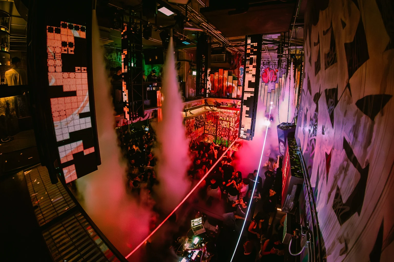 Pink lighting and smoke across the club from the balcony